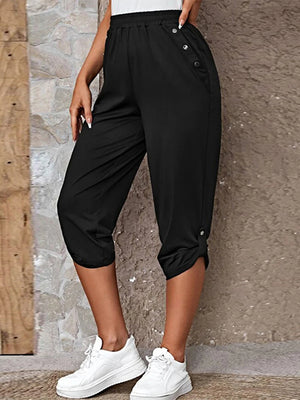 Black culottes with button details at the hip and hem, cropped length