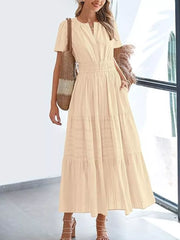 Tan ruched V-neck tiered midi dress with short sleeves and pockets.
