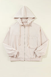 Cream corduroy bomber hoodie with relaxed fit, zip front, drawstring hood, chest pocket and elastic cuffs.