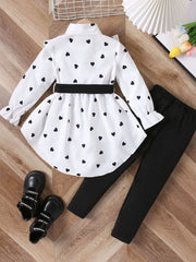 White heart print toddler outfit with black leggings and bow detail.