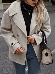 Light gray double-breasted wool blend pea coat with button details and wide lapels.