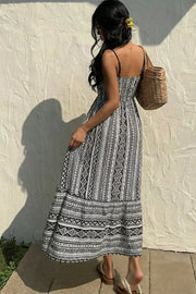 Black and white geometric print maxi cami dress with spaghetti straps and a tiered skirt.