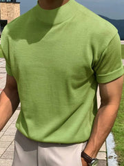 Matcha green knit tee with mock neck and rolled short sleeves.