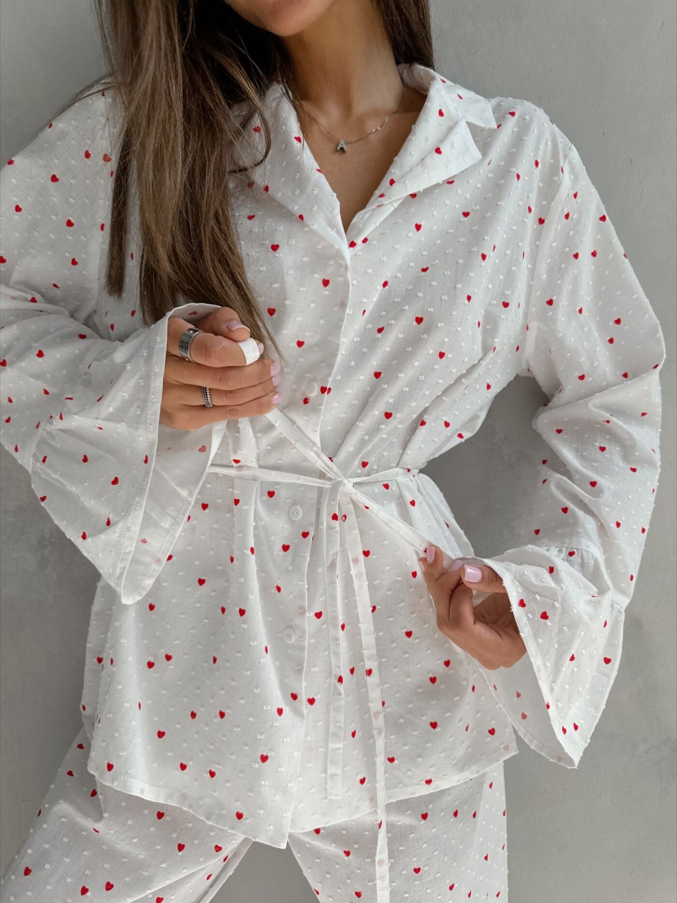 White cotton pajama set with red hearts, button-down collared shirt and tie waist
