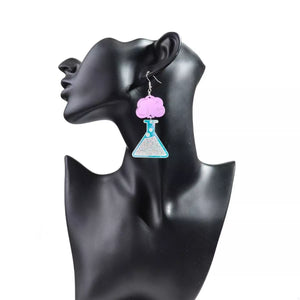 Funky science beaker dangle earrings in fuchsia pink acrylic with glitter detail.