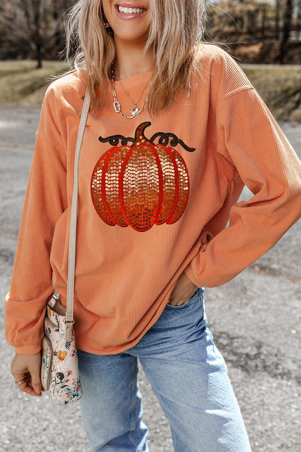Sequin pumpkin corduroy relaxed sweatshirt in sherbet with long sleeves and a crew neck.