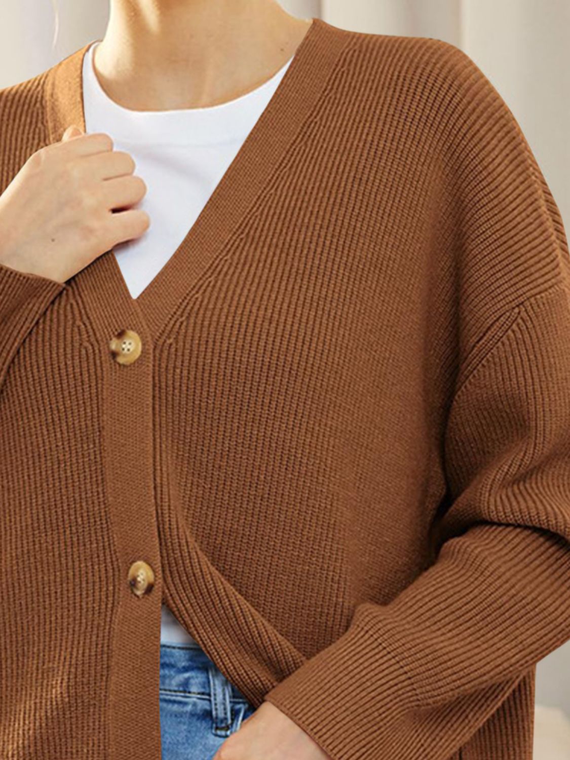 Ochre ribbed knit cardigan with balloon sleeves and button front, worn over a white tee.