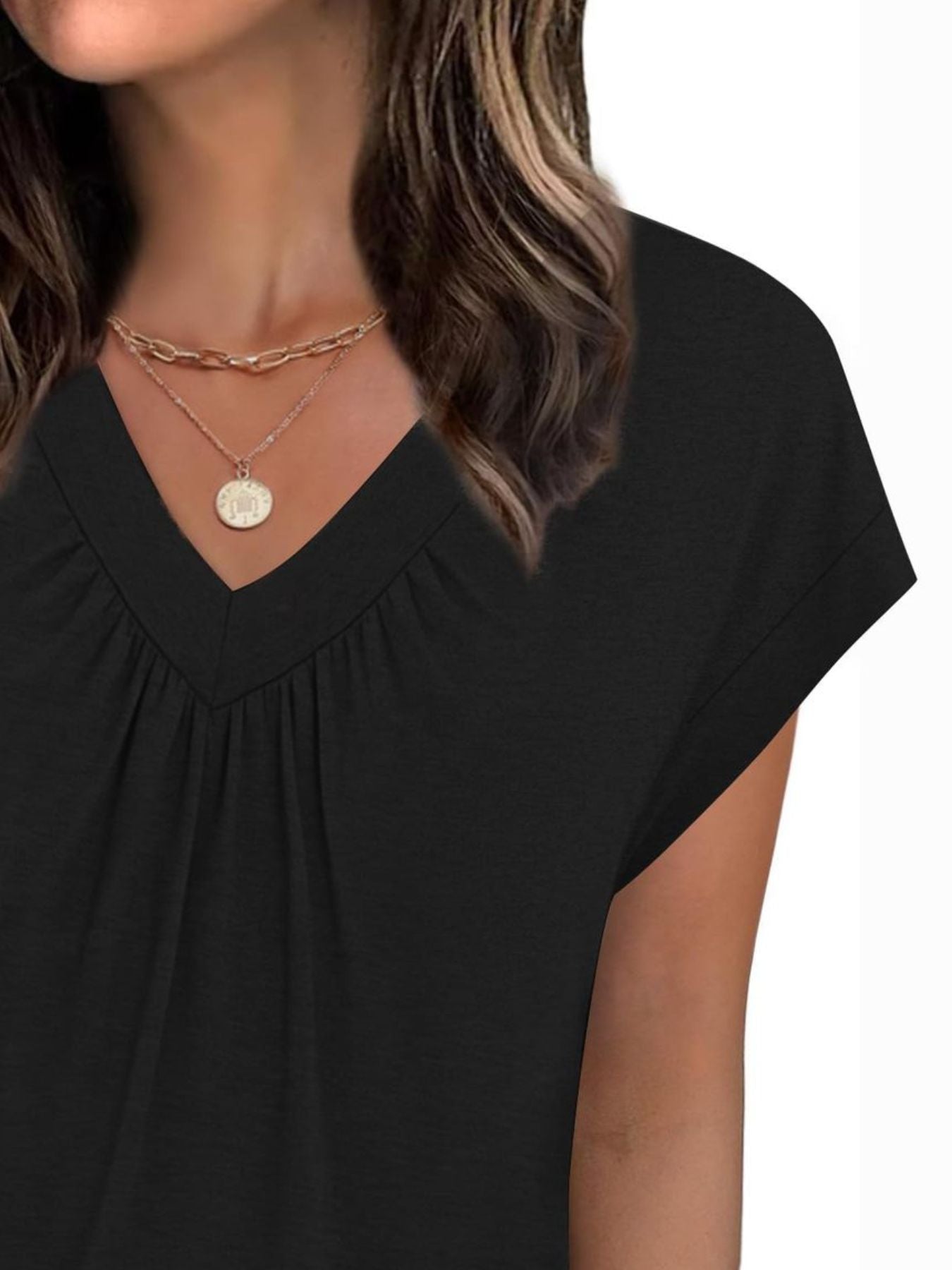 Black ruched v-neck t-shirt with short sleeves and layered gold necklaces.