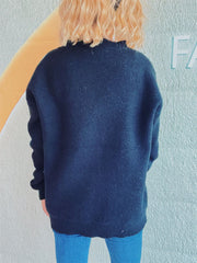 Black acrylic cardigan with a relaxed fit and ribbed hem and cuffs.