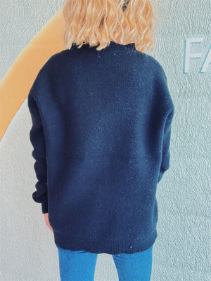 Black acrylic cardigan with a relaxed fit and ribbed hem and cuffs.