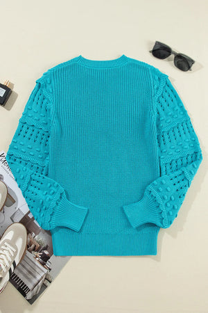 Turquoise knit sweater with textured cutout sleeves and crew neck.