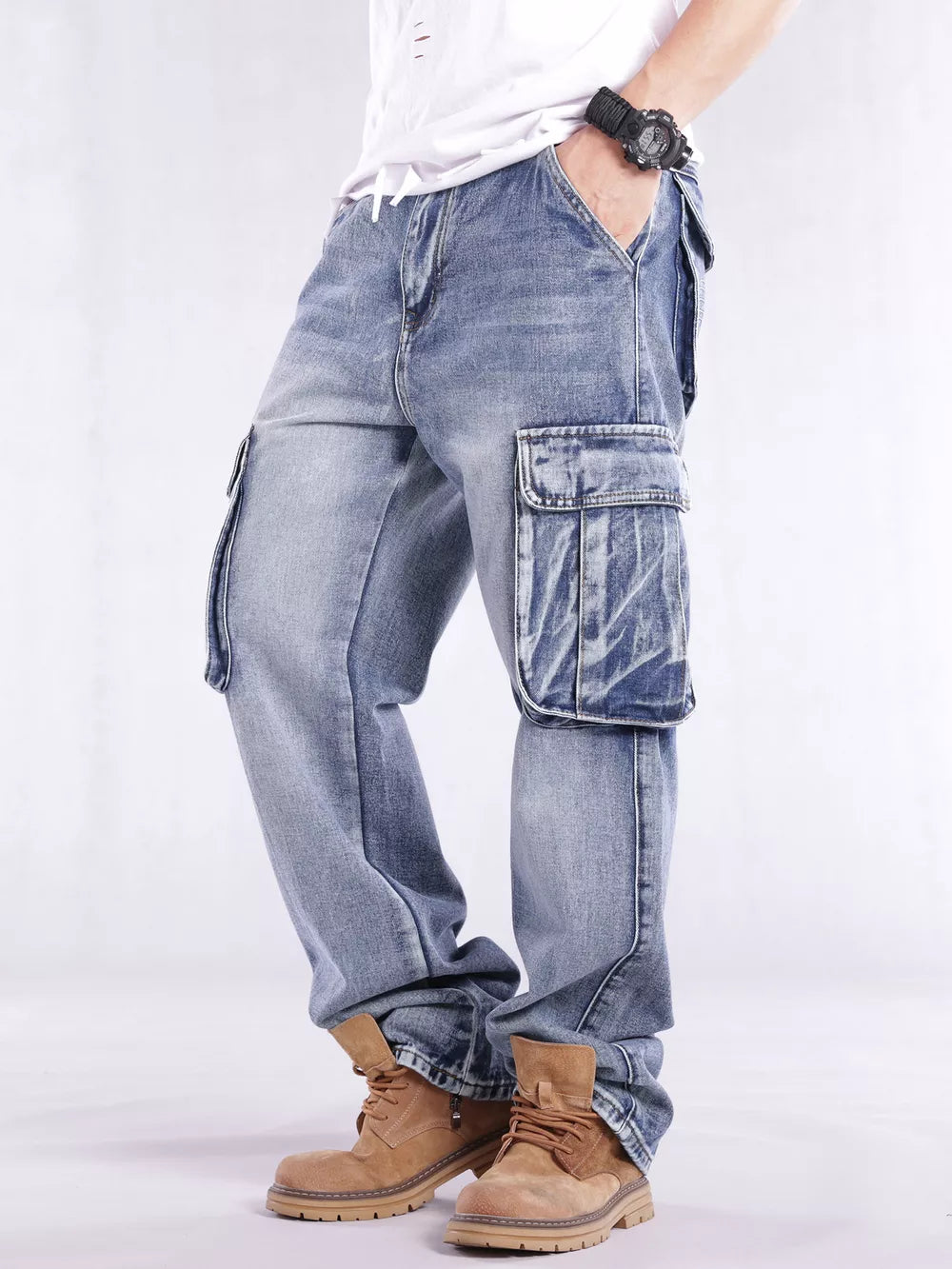 Relaxed fit light wash denim cargo jeans with flap pockets and contrast stitching.