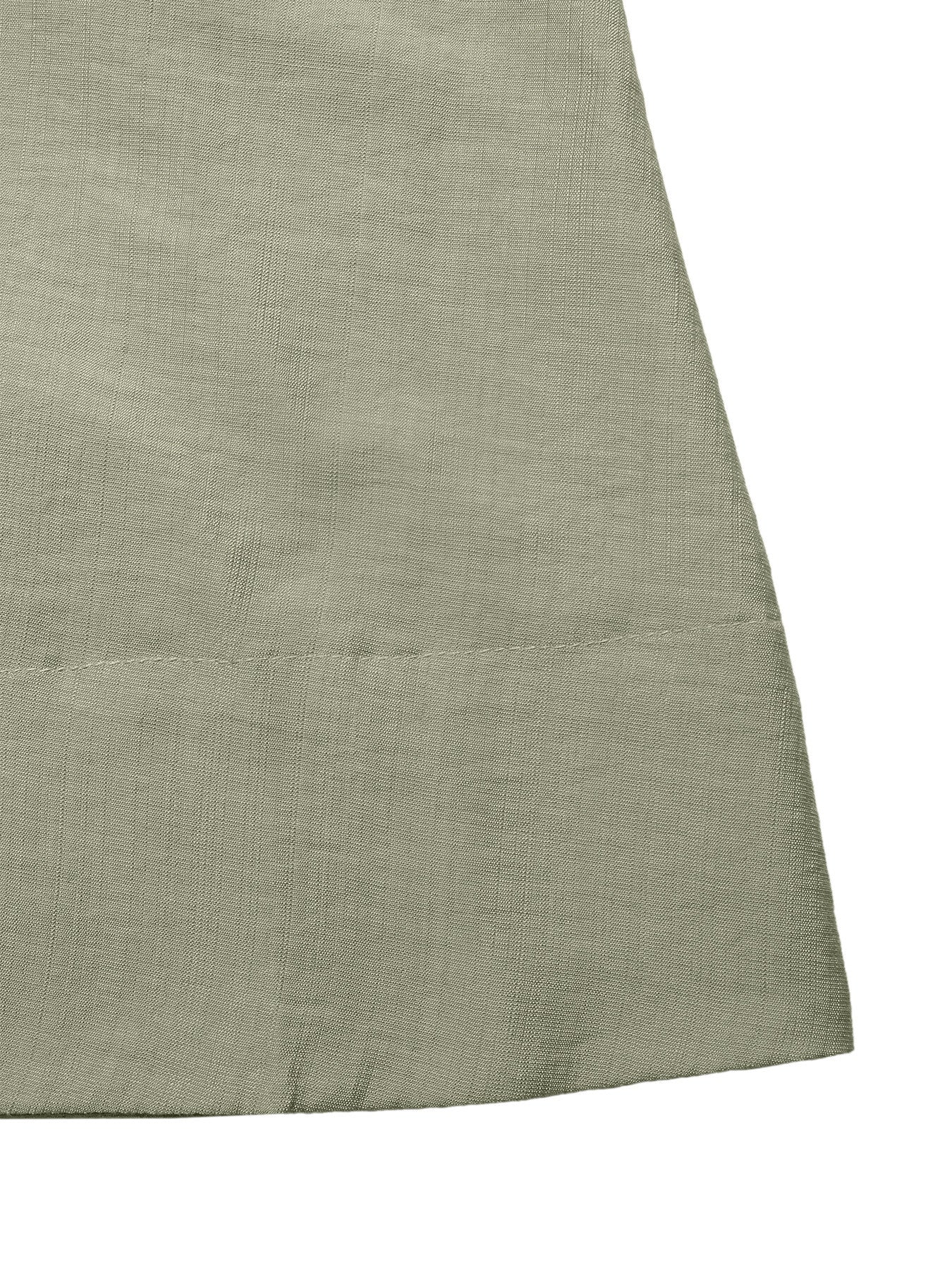 Elegant smocked waist maxi dress in sage green linen blend fabric, showing textured detail.
