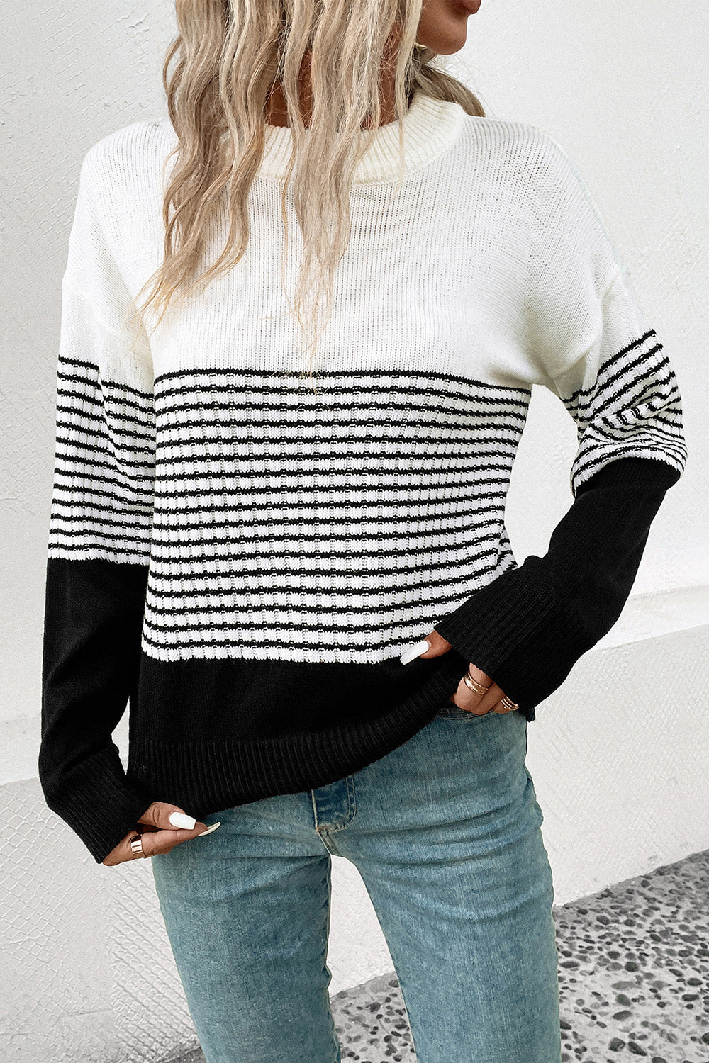 Colorblock stripe crewneck sweater in white and black acrylic with a relaxed fit.