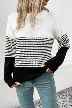 Colorblock stripe crewneck sweater in white and black acrylic with a relaxed fit.