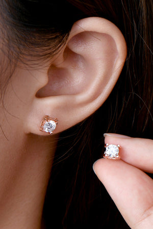Rose gold moissanite solitaire stud earrings with a clear stone.