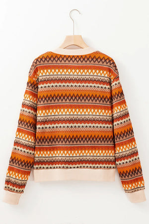 Geometric knit bomber jacket in orange with a zig-zag pattern and ribbed cuffs.
