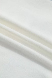 White knit sweater vest fabric detail showing ribbed texture and soft material.