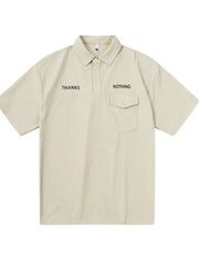 Apricot polo shirt with button detail, chest pocket, and "THANKS NOTHING" text.