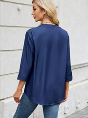 Dark navy denim henley blouse with 3/4 sleeves and a curved hem.