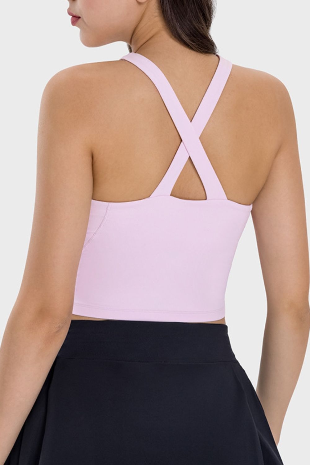 Blush pink active crop top with criss-cross back straps.