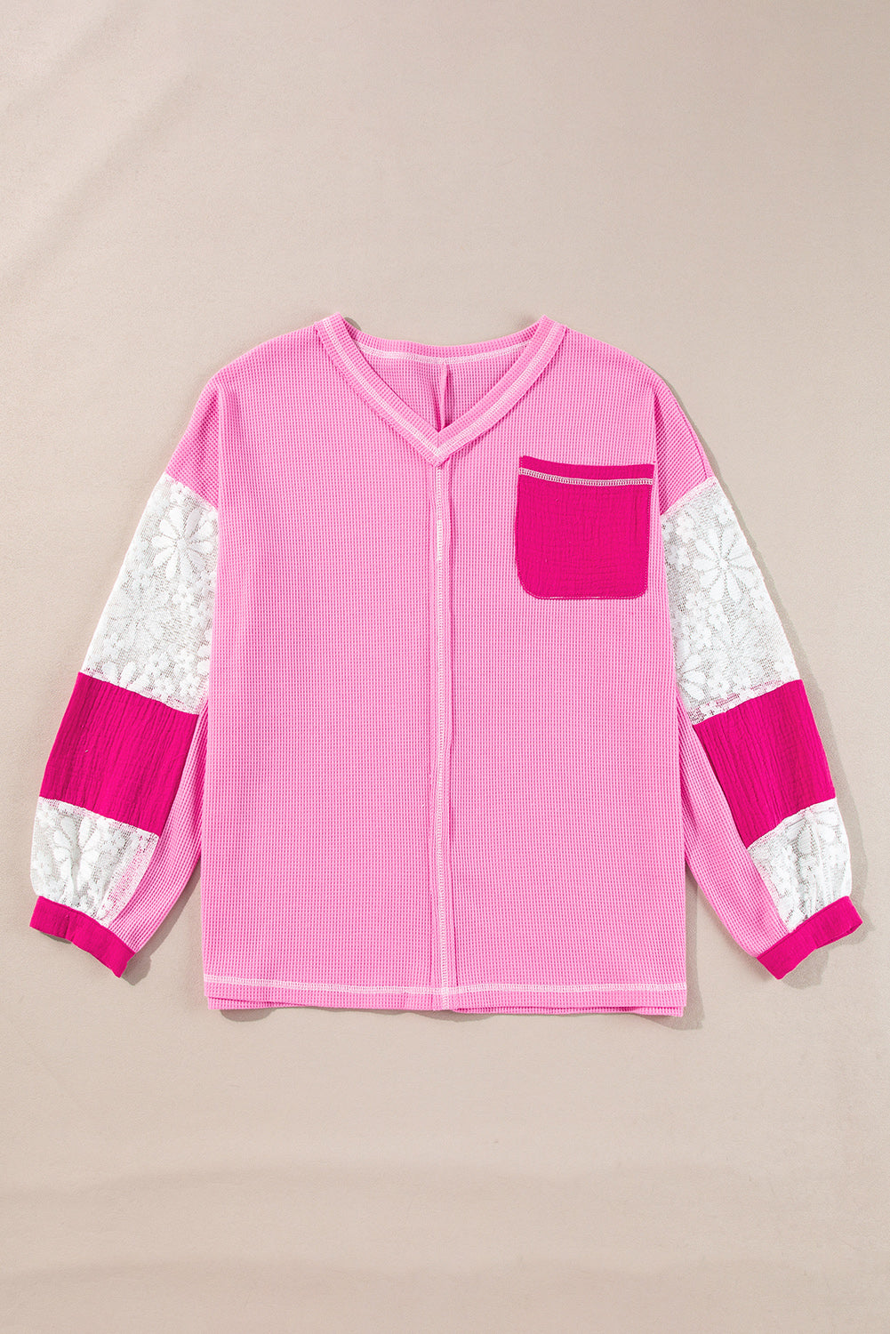 Fuchsia pink waffle knit top with lace paneled sleeves and a chest pocket.