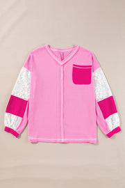 Fuchsia pink waffle knit top with lace paneled sleeves and a chest pocket.