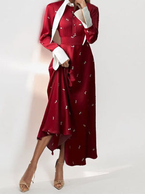 Burgundy midi dress with contrast collar, button-down front, defined waist, and subtle pattern.