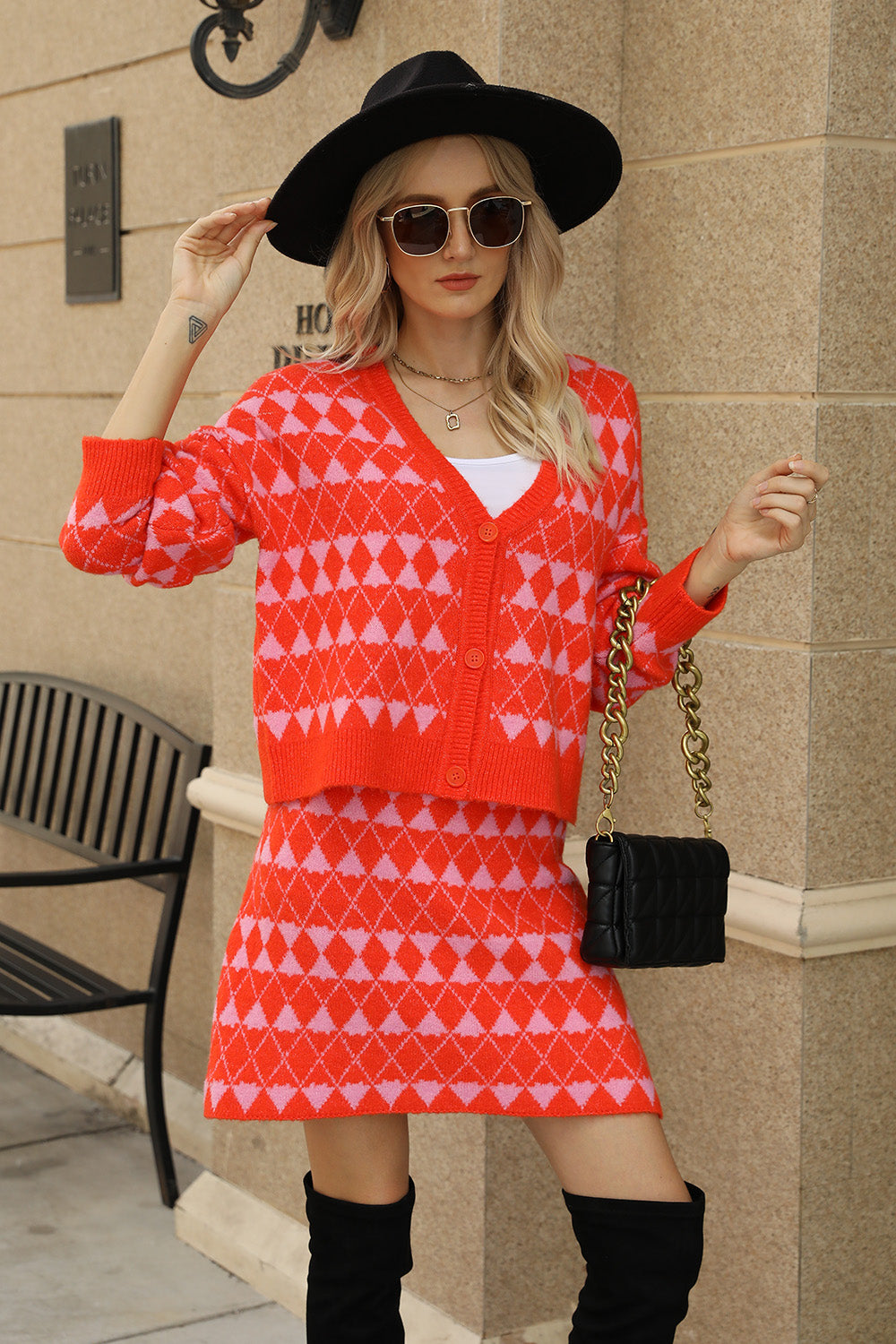 Argyle knit cardigan and mini skirt set in red and pink acrylic with button front.