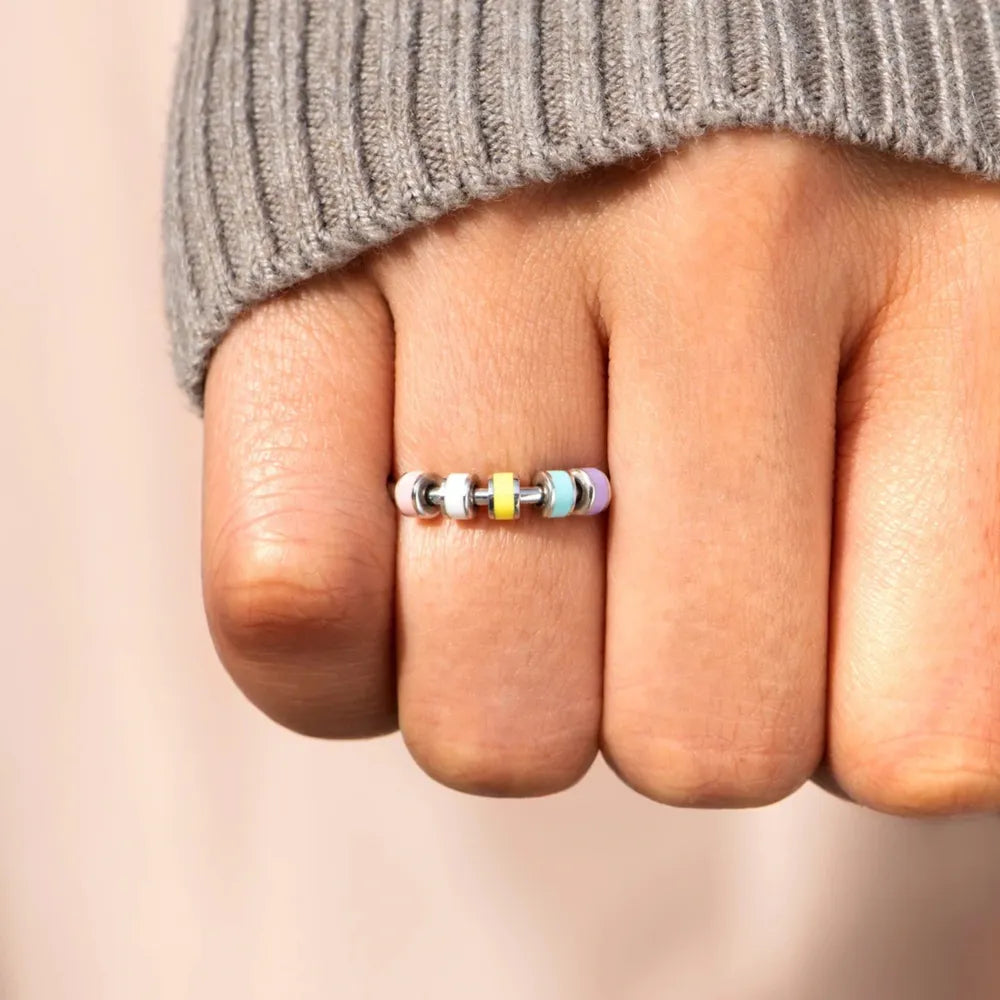 Chromatic bead sterling ring with pastel yellow, blue, and purple beads.