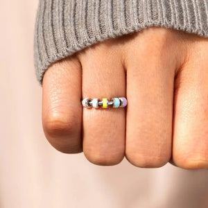 Chromatic bead sterling ring with pastel yellow, blue, and purple beads.
