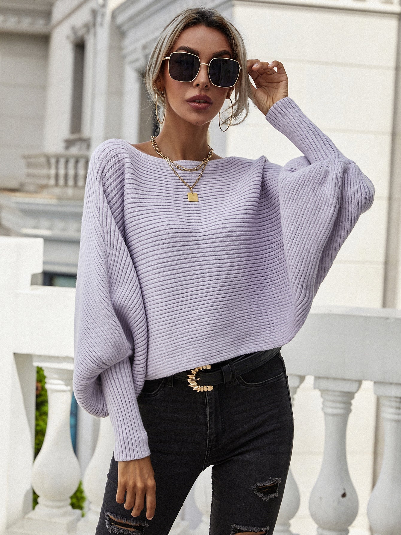 Purple ribbed dolman knit sweater with boat neck and voluminous sleeves.