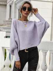 Purple ribbed dolman knit sweater with boat neck and voluminous sleeves.