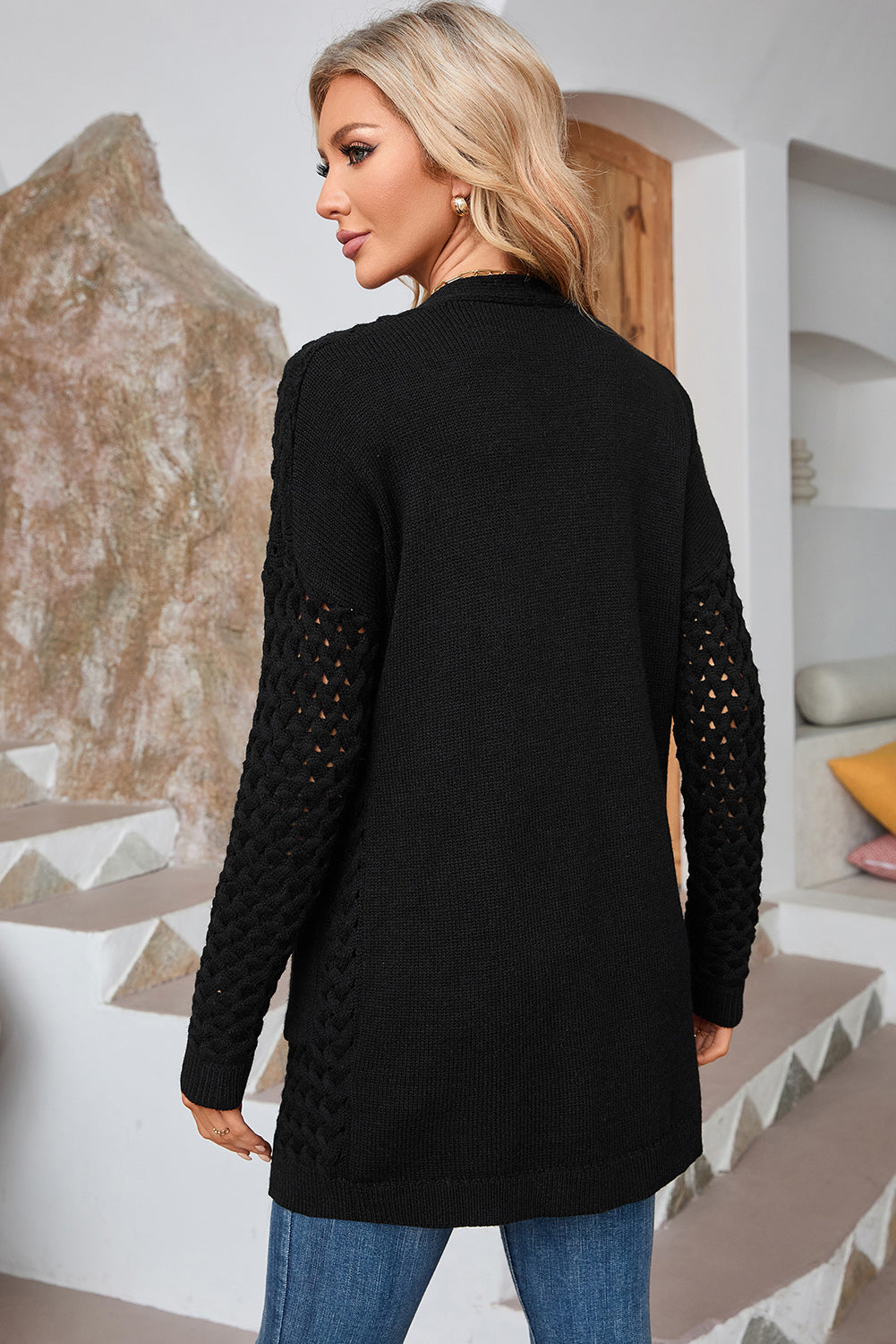 Black open-knit pocket cardigan with textured sleeves and a relaxed fit.