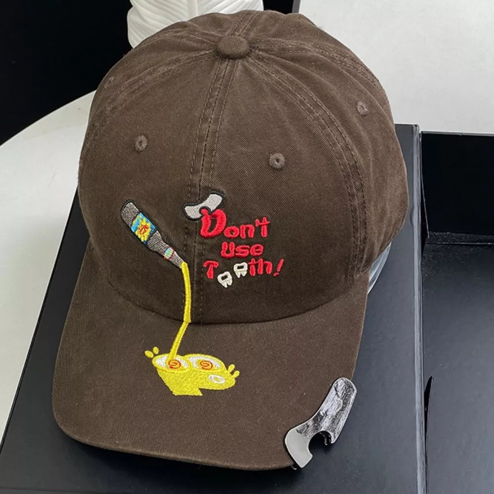 Brown baseball cap with embroidered cartoon bottle pouring into a yellow bowl and text.