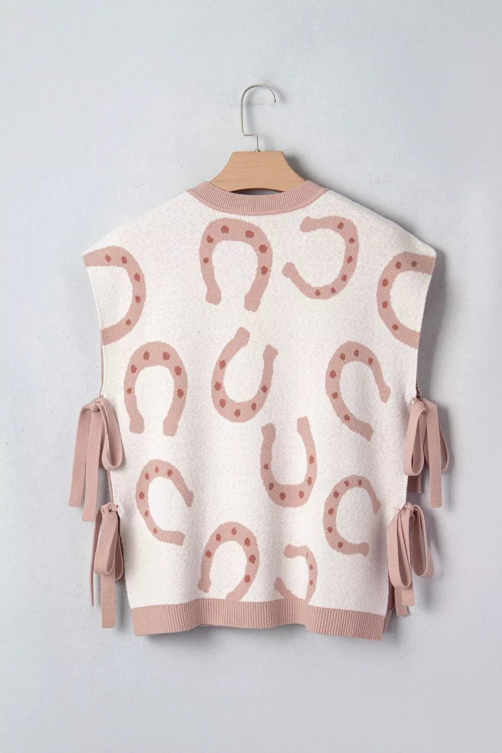 White knit tank top with horseshoe pattern and side ties