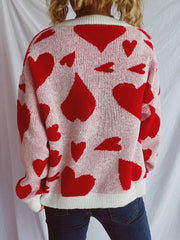 Heart motif knit sweater in pink and red, featuring a crew neck and long sleeves.
