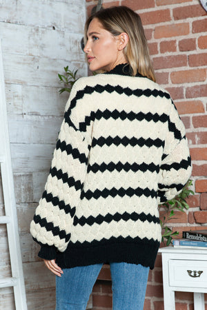 Cream chevron stripe knit cocoon cardigan with balloon sleeves and a relaxed fit.