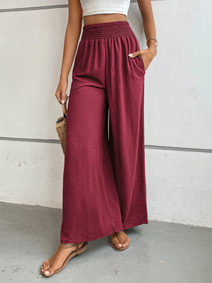 Burgundy textured palazzo lounge trousers with smocked waist and pockets.