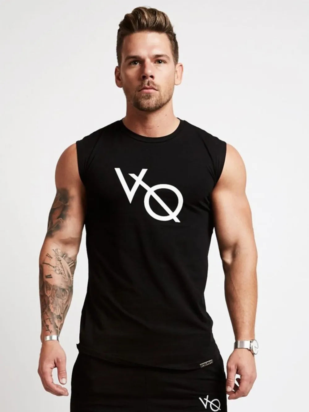 Black graphic muscle tank top with white logo, crew neck, sleeveless.
