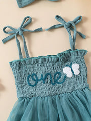 Sea blue smocked baby bodysuit with embroidered "one" and butterfly detail, tie straps.