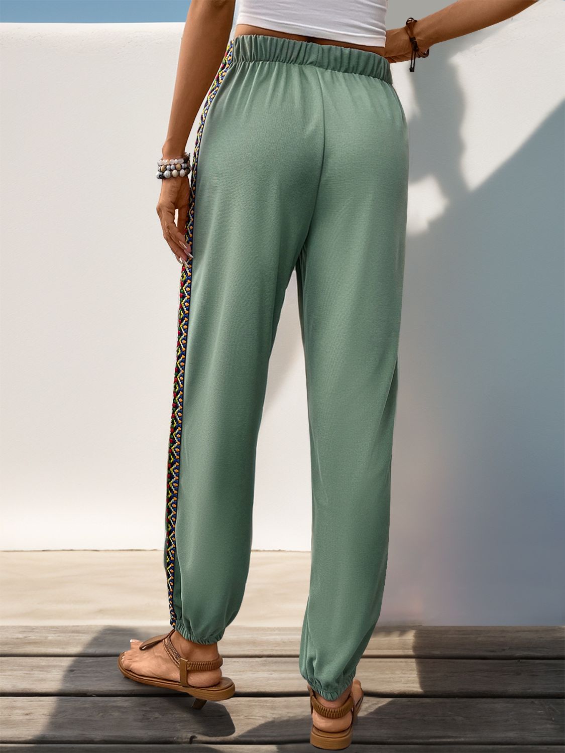Gum Leaf relaxed-fit joggers with embroidered side trim and elastic cuffs.