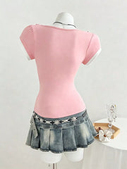 Pink maternity t-shirt with short sleeves, white trim, and a bow detail on the shoulder.