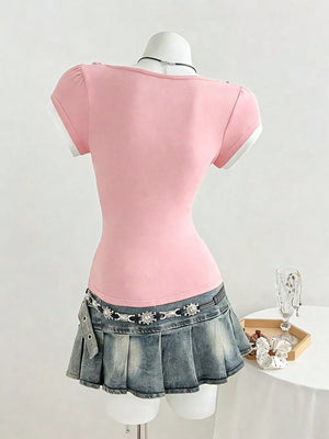 Pink maternity t-shirt with short sleeves, white trim, and a bow detail on the shoulder.