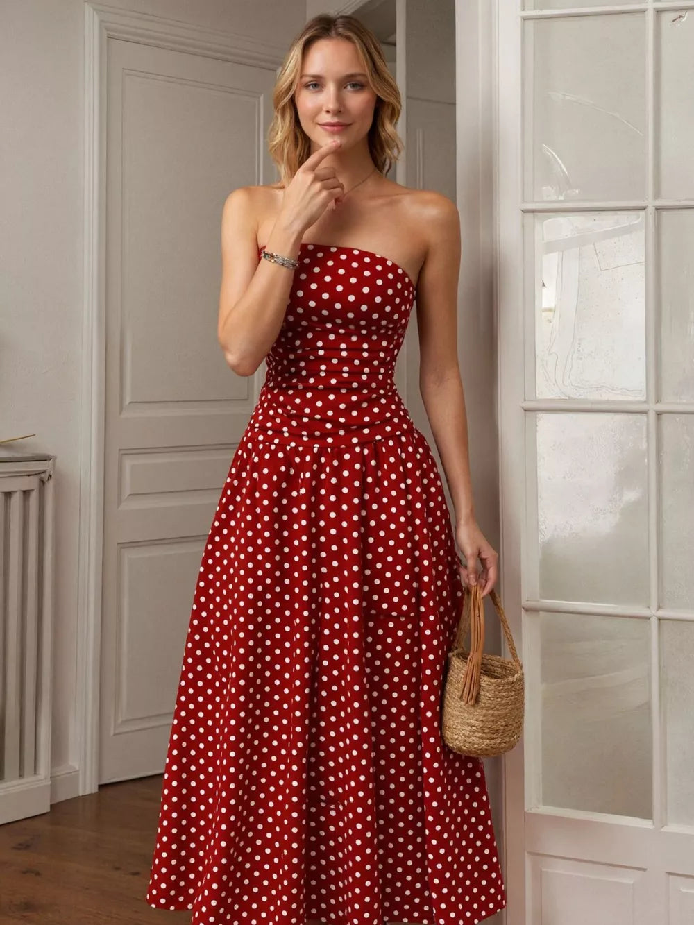 Red polka dot strapless maxi gown with a cinched waist and full skirt.