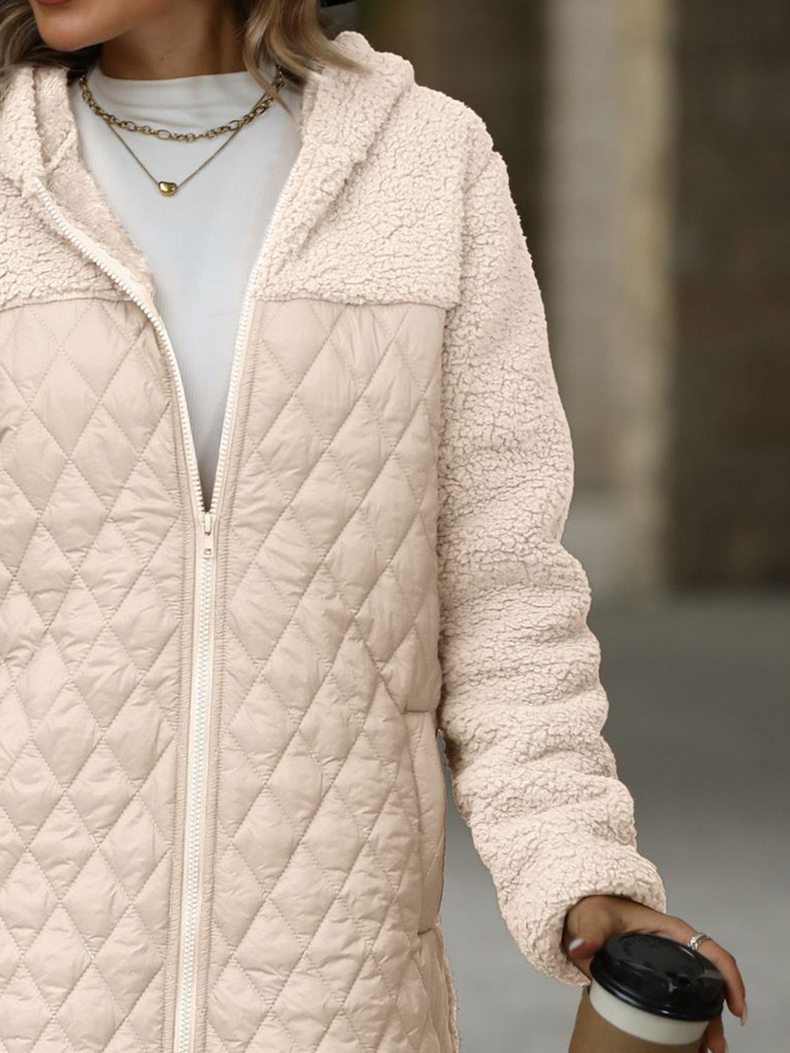 Eggshell quilted puffer coat with teddy fleece sleeves and hood, zip front.