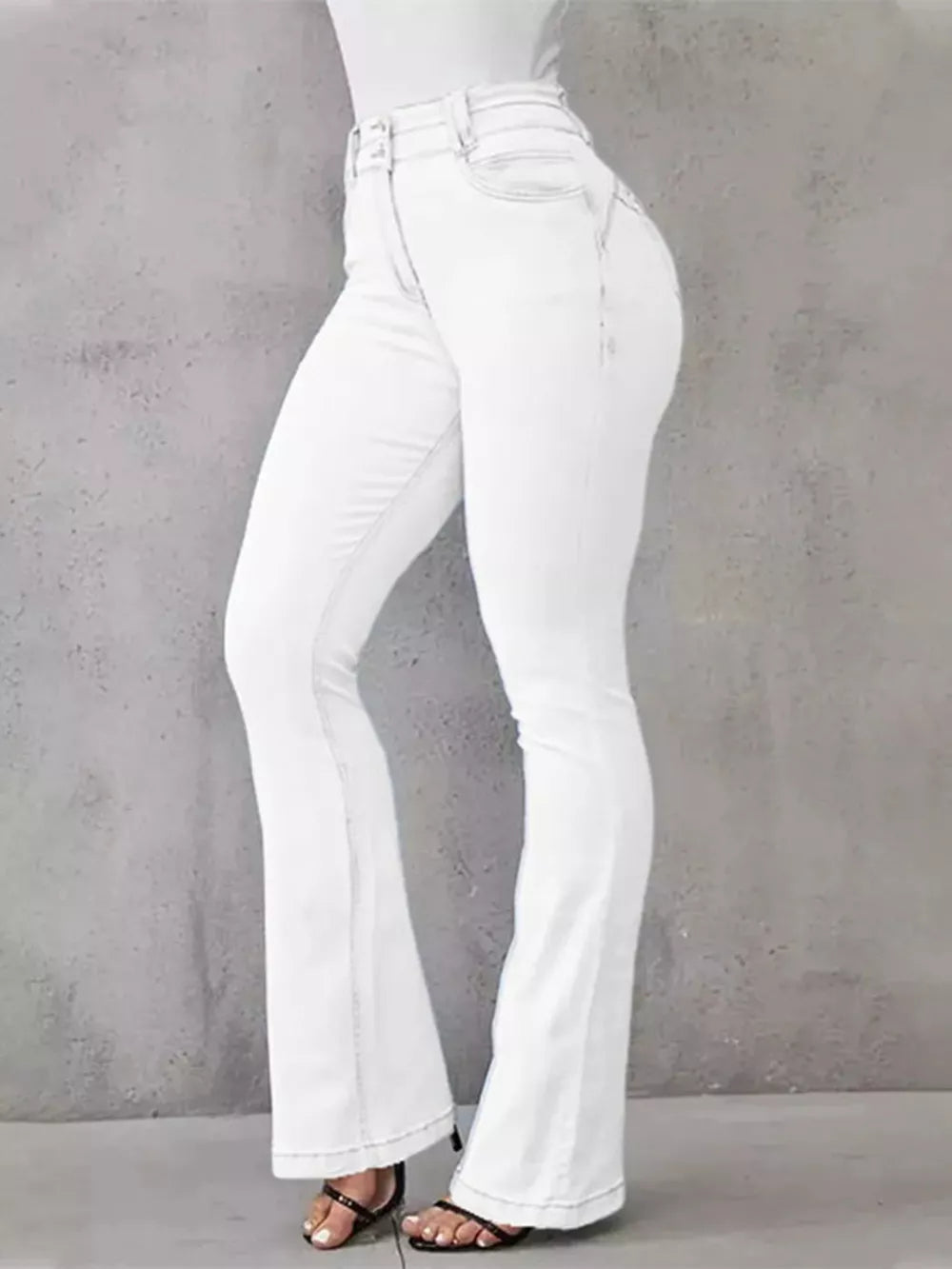 White high-waisted flare jeans with button closure and a cotton spandex blend.