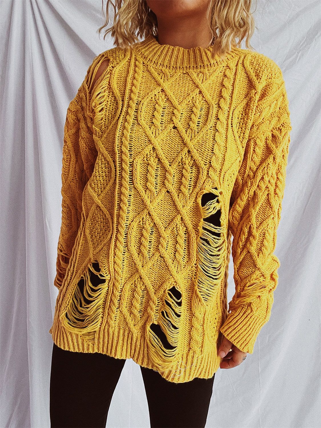 Mustard yellow distressed cable knit sweater with ripped details