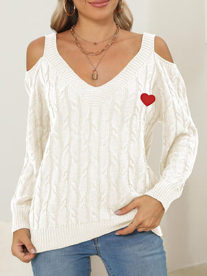 White open shoulder cable knit sweater with red heart detail and v-neck
