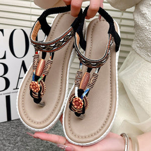 Ethnic patterned wedge sandals with floral accents and beaded straps in khaki.